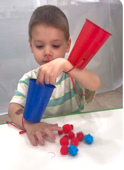 Child with sensory cups at Fairy Tale Child Care