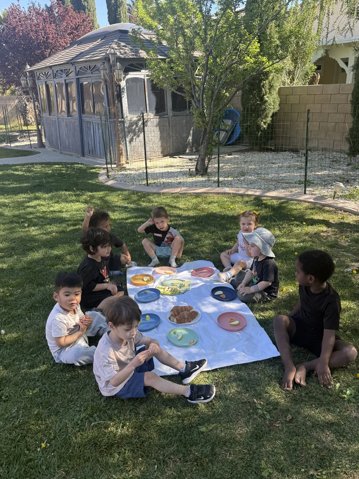 Children Enjoying Outdoor Picnic Lunch Together at Fairy Tale Child Care Palmdale