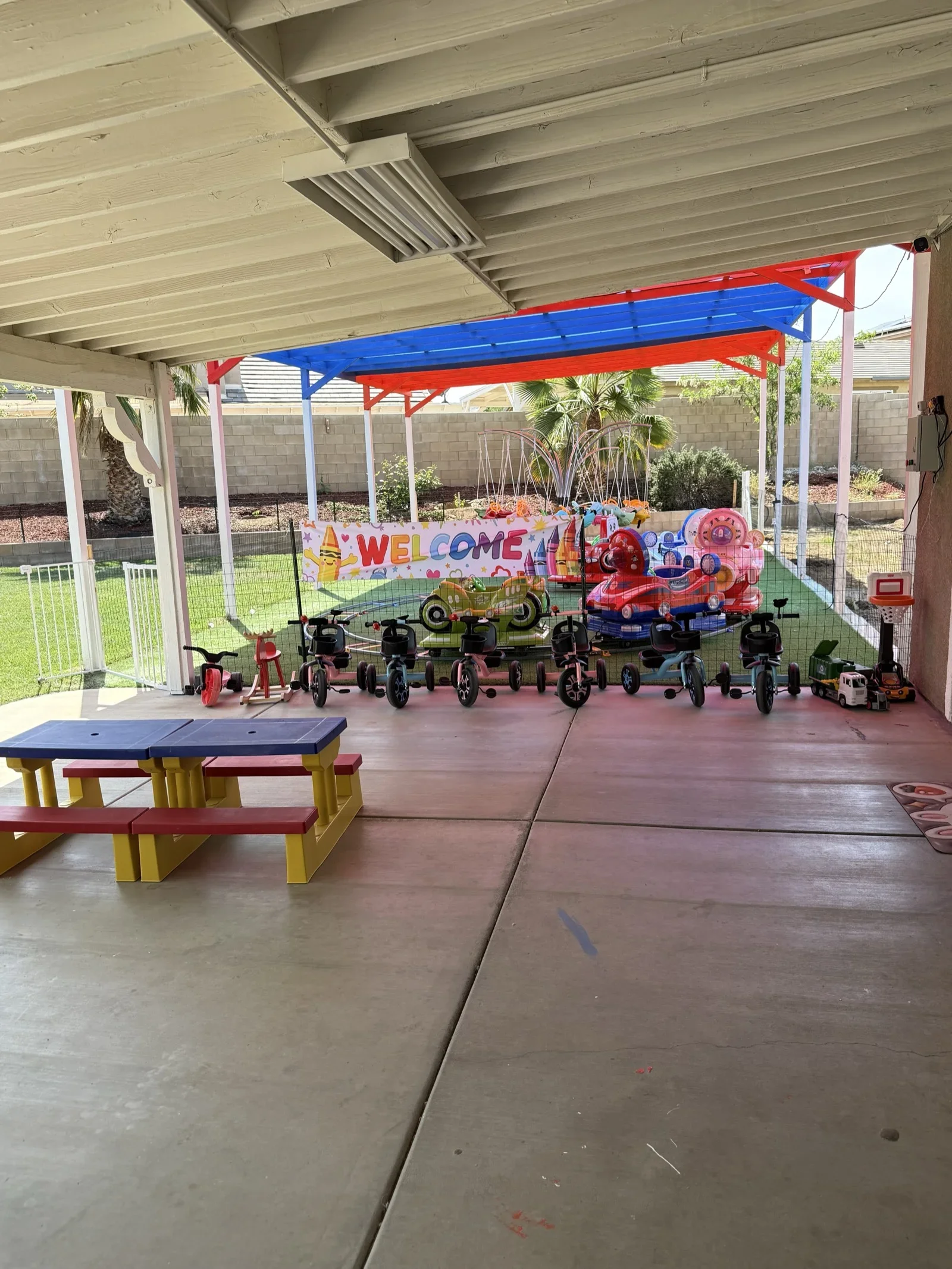 Covered Patio with Trikes and Welcome Sign at Fairy Tale Child Care Palmdale