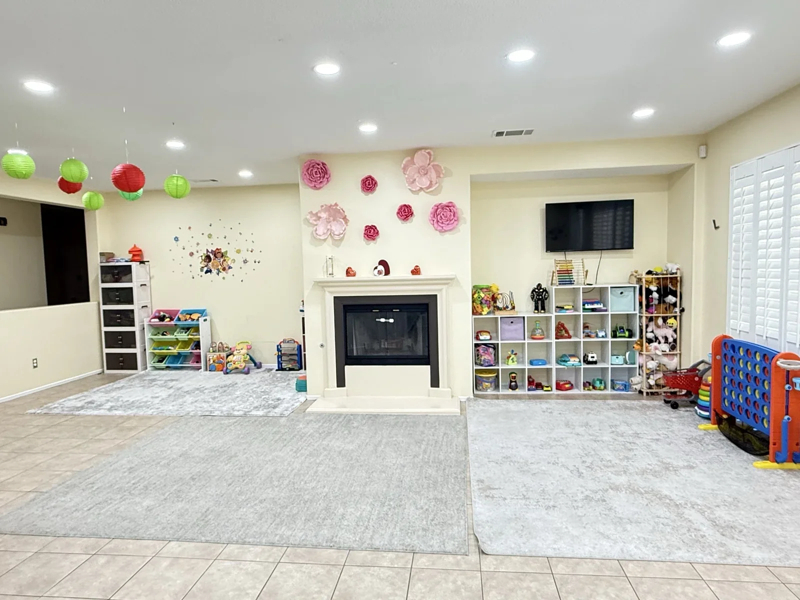 Spacious Indoor Play Room with Toys and Cozy Fireplace at Fairy Tale Child Care Palmdale