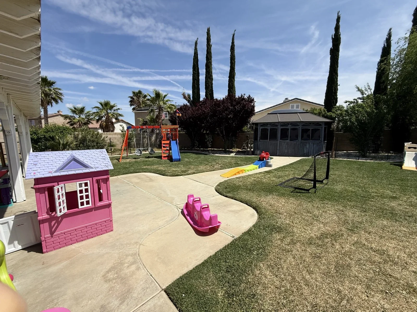Pink Playhouse and Swingset in Backyard at Fairy Tale Child Care Palmdale