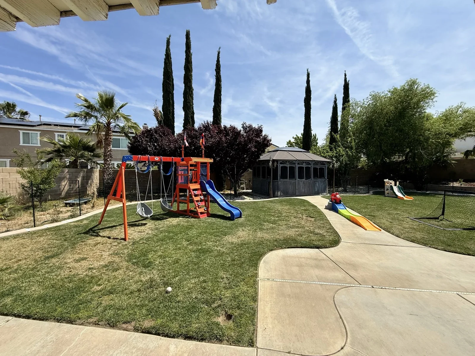 Swing Set and Slide in Green Backyard at Fairy Tale Child Care Palmdale